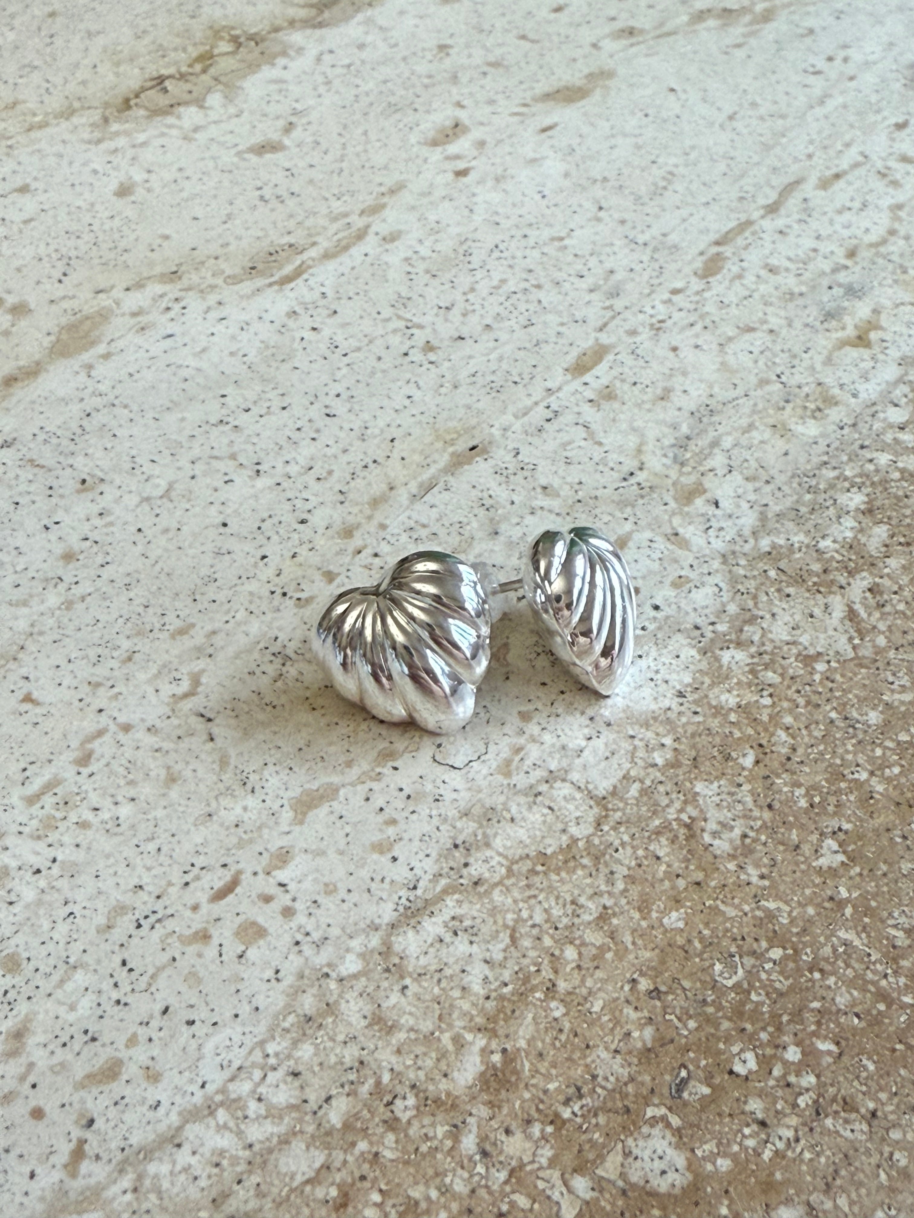 Silver shell-shaped earrings.