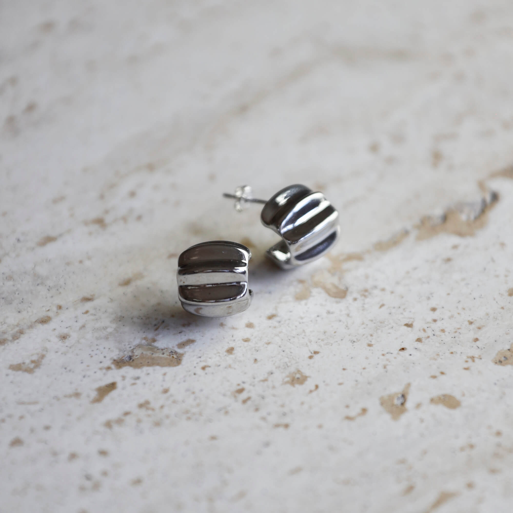 Sterling silver statement huggie earrings with bold sculptural design, modern elevated style. - Solinu Jewellery